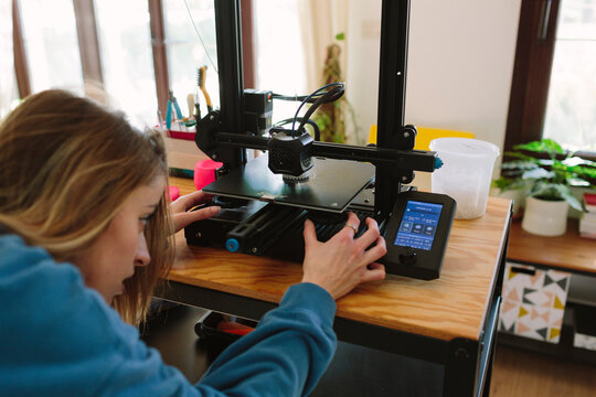 Woman working on a 3D printer