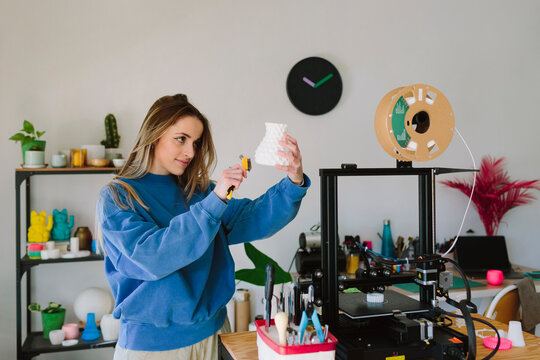 Woman working on a decorative vase