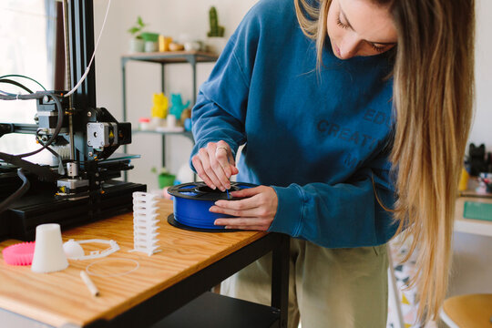 Woman working with a 3D printer