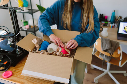 A woman packs up items for online selling