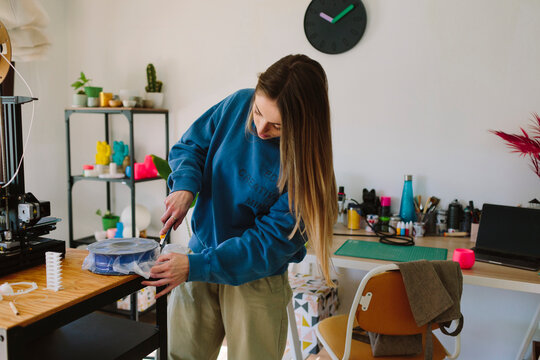 A woman opens a material box