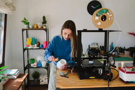 Woman using a 3D printer