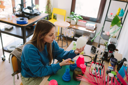 A woman works crafts at her desk