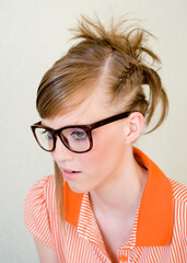 Cute girl wears designer glasses on light background