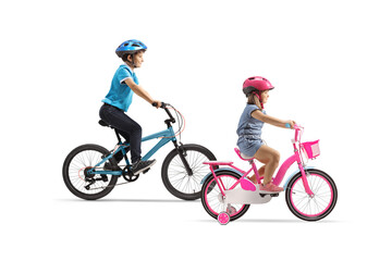 Full length profile shot of a boy and girl bicycles and wearing helmets