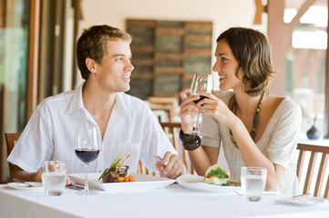 A young couple sitting at a table at an outdoor restaurant