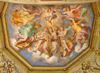 GENOVA, ITALY - MARCH 6, 2023: The ceiling fresco of Choir of angels with the music instruments in the church Chiesa di Santa Caterina by Andrea Semino (1525 - 1595).