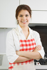 Portrait of a pretty young woman in the kitchen