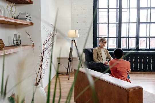 Diverse psychotherapist and patient during session in modern office