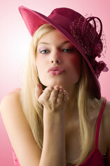 very nice girl with blue eyes and red hat giving a virtual kiss