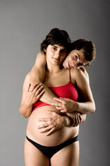 Naklejka premium Beautiful happy couple in love expecting a baby