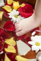 Aromatherapy, flowers children feet bath, colorful rose petal