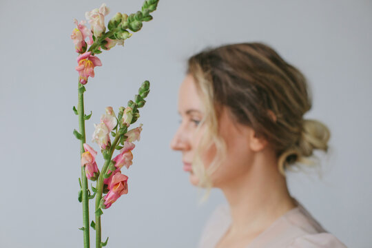 profile portrait of blurry woman and flowers 
