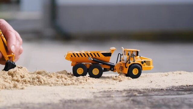 Children's YouTube channel. How to make a video for a children's YouTube channel. Games with a yellow excavator and a truck in the sand. Construction concept.