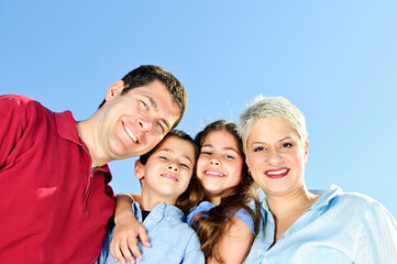 Portrait of happy family of four smiling