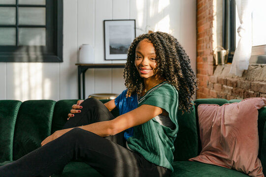 portrait of happy  young woman sitting in the sun  