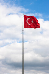Turkish flag, hoisted waving red star Turkish flag. Selective focus, noise effect.