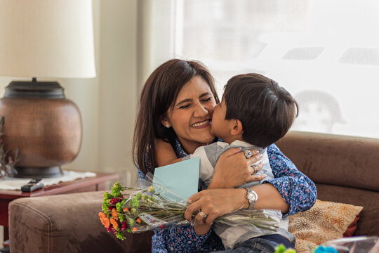 Little Boy Gives Gifts To His Mom And Hugs Her