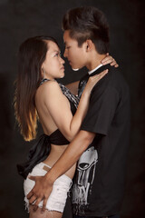 Young asian couple touching about to kiss
