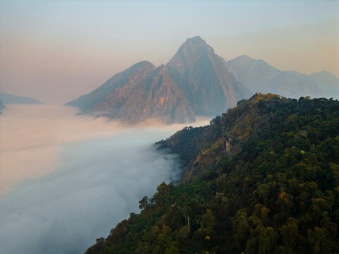 Aerial view of mountains in fog at sunrise 