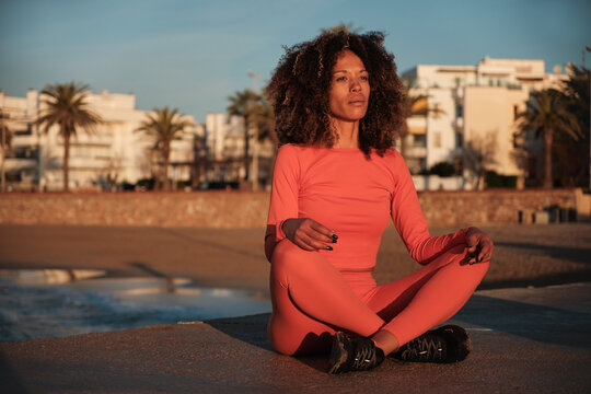 Relaxed woman doing meditation outdoors