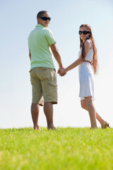 happy young couple walk on the park