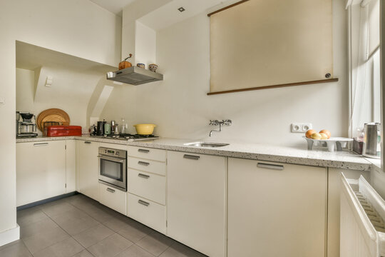 a kitchen with white cabinets and counter space for the dishwasher to be used as a sink in this photo