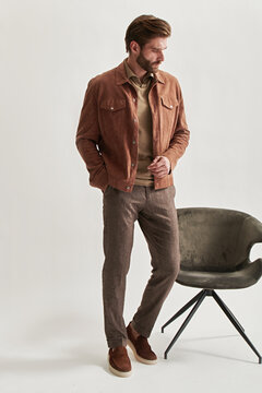 Fashion portrait of a stylish man in full growth on a light background