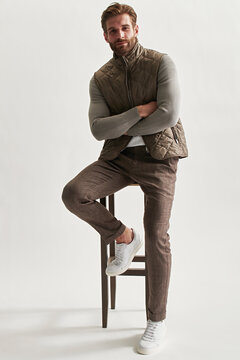 Fashion portrait of a stylish man in full growth on a light background