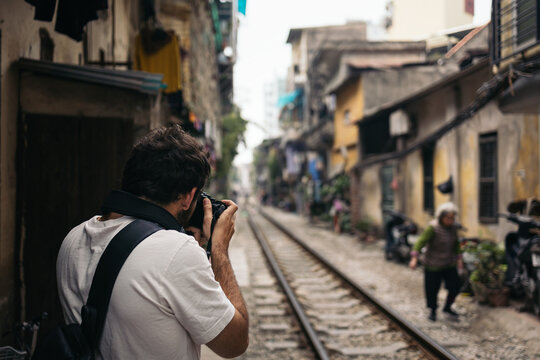 Tourist visiting Hanoi taking photos with camera