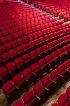 Many red seats in empty theater area