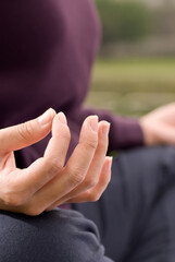 Yoga pose of lotus of woman hand in outdoor.