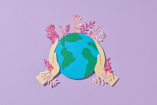 A globe with flowers in paper cut and craft style