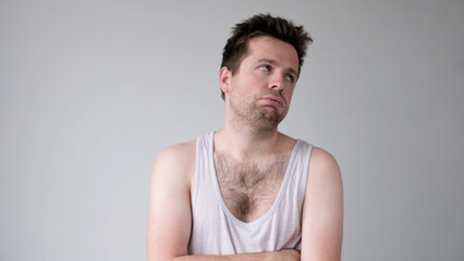 the tired European young man looks dejectedly, without strength and energy