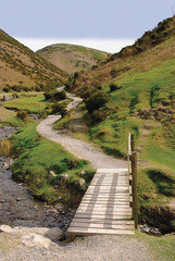 A stream and a footpath uphill in the carding mill valley shropshire england uk