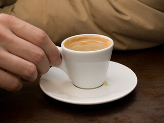 Man's hand with the cup of espresso