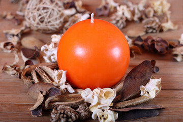 Orange candle and dried plants