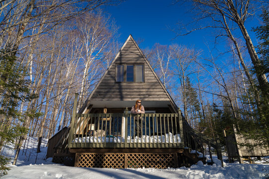 Woman Relaxing at Cottage in WInter Forest