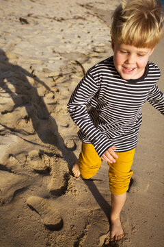 boy have a fun on the ocean cost beach