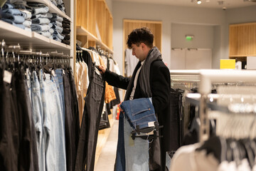 Young adult shopping for clothes at store