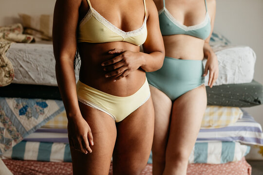 Cropped image of the body of two women in underwear