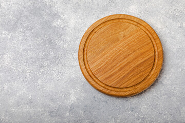 Cutting board on gray kitchen table texture background. Recipe. Kitchenware. Empty modern wooden cutting board. MOCKUP. Place for text. Place to copy.