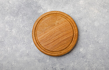 Cutting board on gray kitchen table texture background. Recipe. Kitchenware. Empty modern wooden cutting board. MOCKUP. Place for text. Place to copy.