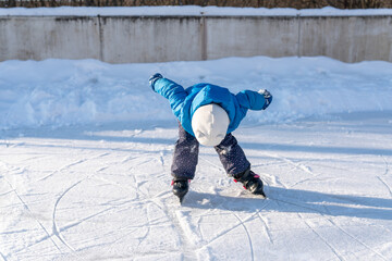 child makes first attempts at ice skating