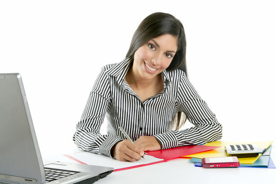 Beautiful secretary businesswoman writing on her desk isolated on white