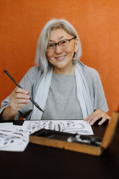 portrait of  female calligrapher creating calligraphy works