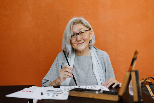 Senior woman practicing calligraphy