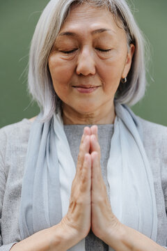 portrait of mature woman with praying hands