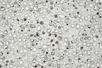Pumice stone, grey porous structure close-up, uniform texture background