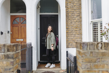 Woman leaving home and closing door